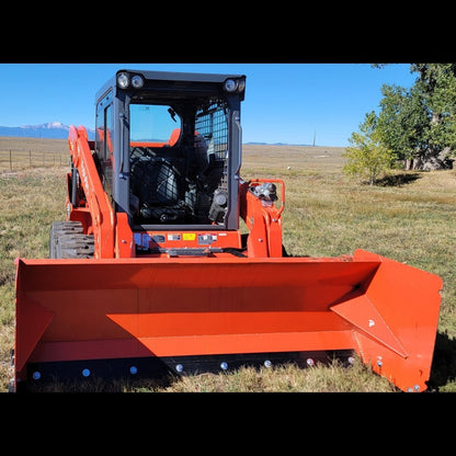 Kubota SSV75 skid steer with 92-inch orange snow pusher, head-on view