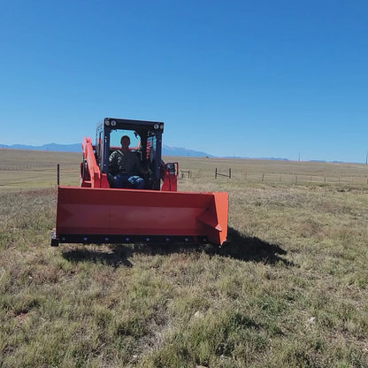 Kubota SSV75 skid steer driving with 92-inch orange snow pusher (video)